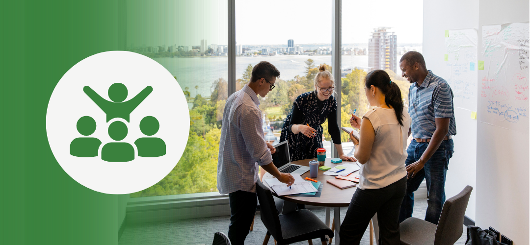 4 Strategies for Leading Change and Driving Innovation in Uncertain Times "Five diverse colleagues collaborating around a table in a modern office with large windows and a scenic city view. A circular icon on the left features a group of people with one figure raised, symbolizing leadership or teamwork."