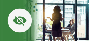 A woman stands and addresses a group in a glass-walled conference room, delivering a presentation. The left side of the image features a green overlay with a white circle and an icon of an eye crossed out—symbolizing invisibility or unconscious bias in leadership or communication dynamics.