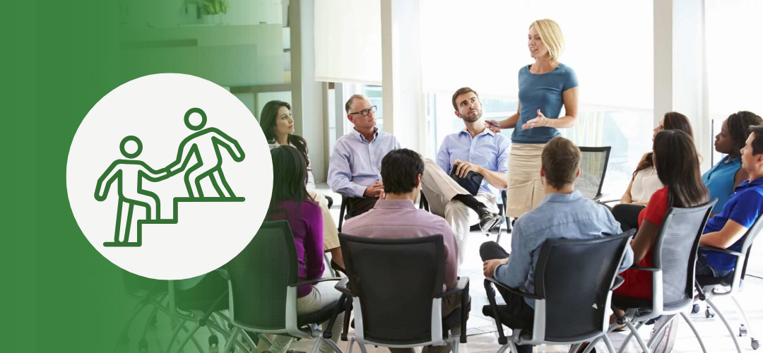 Businesswoman leading a diverse group training session, representing the difference between management training and leadership development in the workplace.